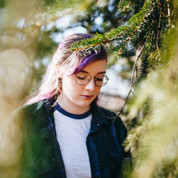 teen girl walking in forest